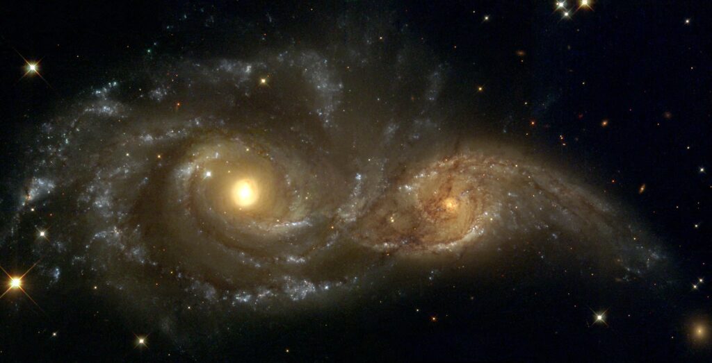 Две спиральные галактики, проходящие друг мимо друга, как величественные корабли в ночи.