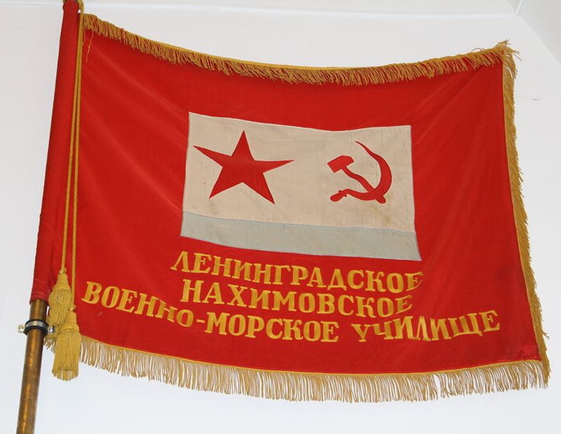Красное Знамя военно-морских частей ВМФ СССР общего образца с подписью «ЛНВМУ» под Военно-морским флагом СССР.